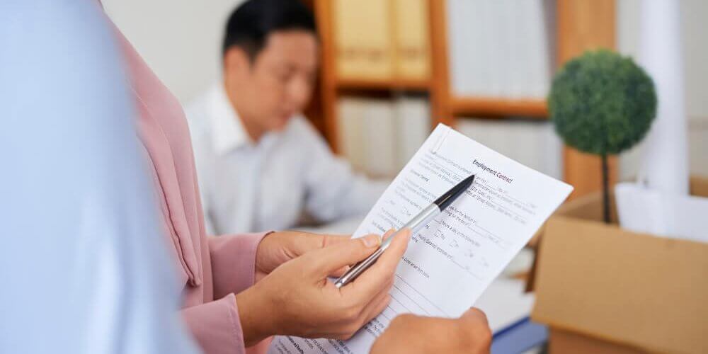 Hands of businesswoman explaining employment contract details to applicant